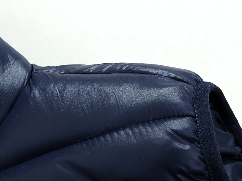 Close-up of a navy blue casual zipper thermal vest showing shiny polyester fabric and stitching details.